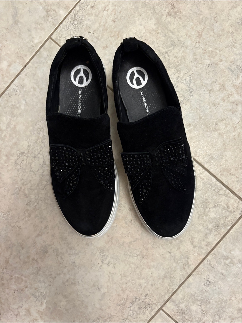 The wishbone Women's Black Slip-On Sneakers with Bow Accent